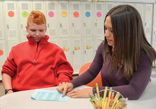 CHA student working with a teacher on his individualized behavioral plan