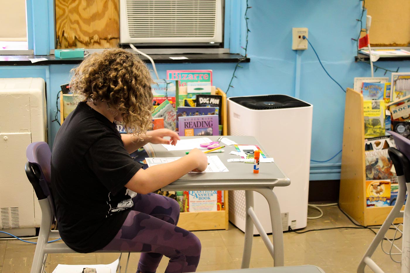 two female students working in a biology lab with female teacher